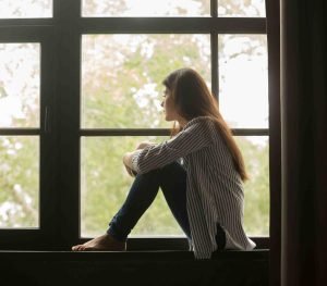 Mujer mirando por la ventana ignisnatura